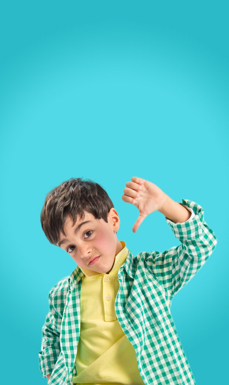 Boy in green plaid shirt with his thumb pointing down
